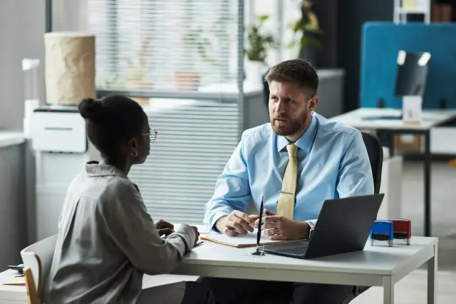 A banker meeting with a client at a desk